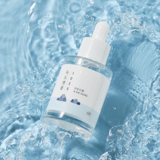 ProtoClinical k-beauty abstract beauty graphic with a bright pale center and darker blue side panels.