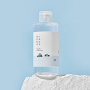 ProtoClinical k-beauty Round Lab 1025 Dokdo Toner 200ml abstract beauty graphic with soft peach, aqua, and violet tones on a pale background