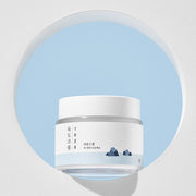 ProtoClinical k-beauty ROUND LAB 1025 DOKDO Cream 80mL abstract beauty graphic with pastel aqua, pink, and lavender diagonal bands on a pale background.