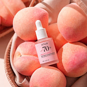 ProtoClinical k-beauty Anua PEACH 70% NIACINAMIDE SERUM 30ml pink glass dropper bottle with a white cap on a plain background