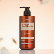 ProtoClinical k-beauty KUNDAL HONEY & MACADAMIA Natural Shampoo (Baby Powder) 500ml single tall warm brown shampoo bottle centered on a soft cream background with pale green side accents.