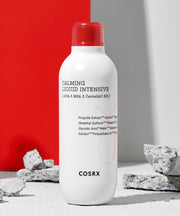 ProtoClinical k-beauty COSRX AC Collection Calming Liquid Intensive 125ml single upright treatment bottle centered on a white background with soft red and gray accents