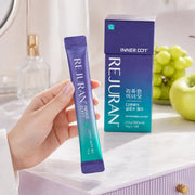 Hand holding one REJURAN Inner Dot DNA Glow Jelly 15 g stick beside the box